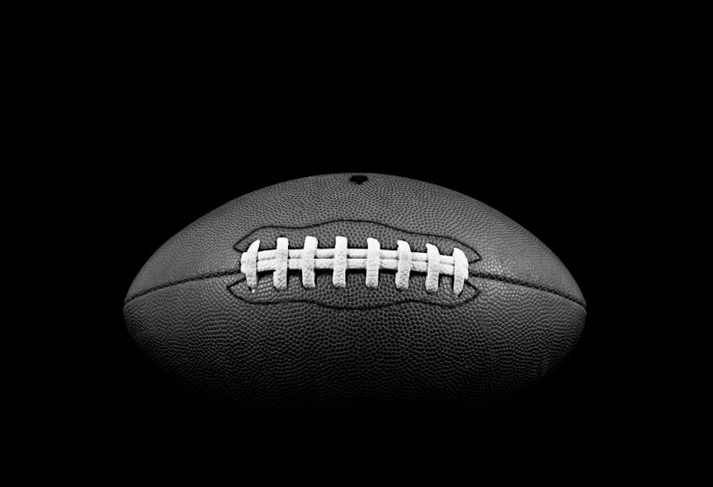 B&W studio shot of American leather football