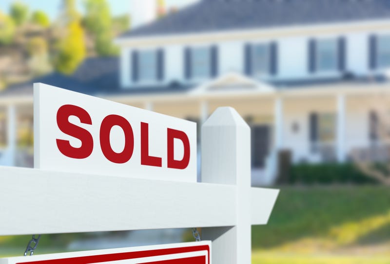 A sign shows a formerly "For Sale" house has been sold