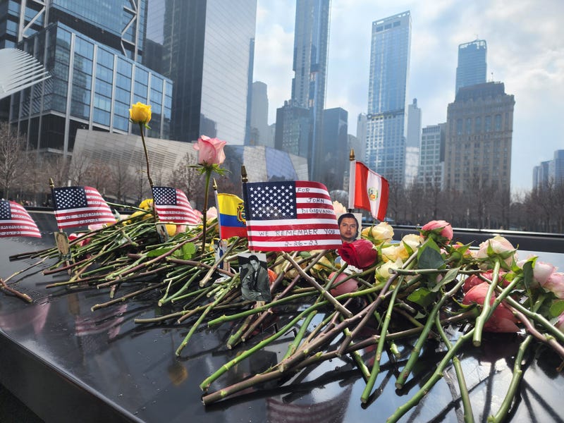 Roses and pictures of those killed from the 1993 bombing of the World Trade Center are seen during the 30th anniversary commemoration in Lower Manhattan on Feb. 26, 2023