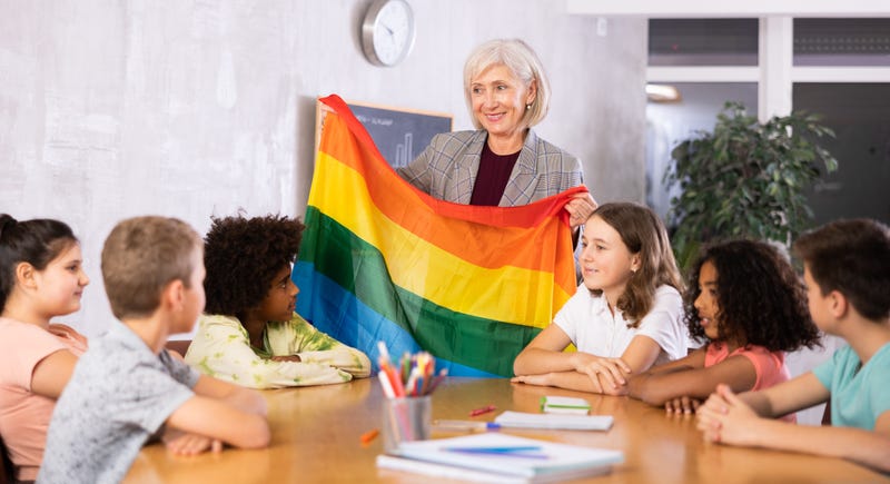 teacher, LGBTQ pride flag, students