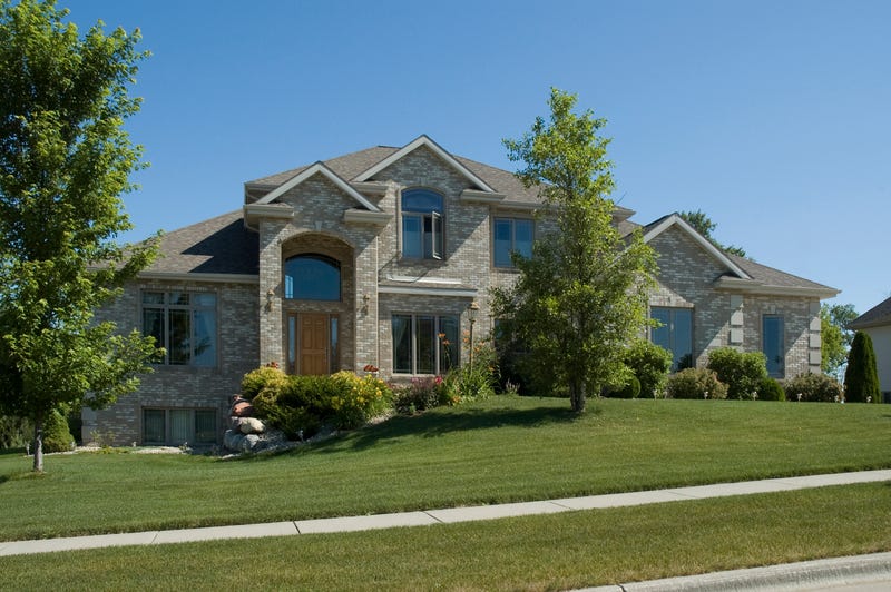 A custom home sits in an upscale neighborhood