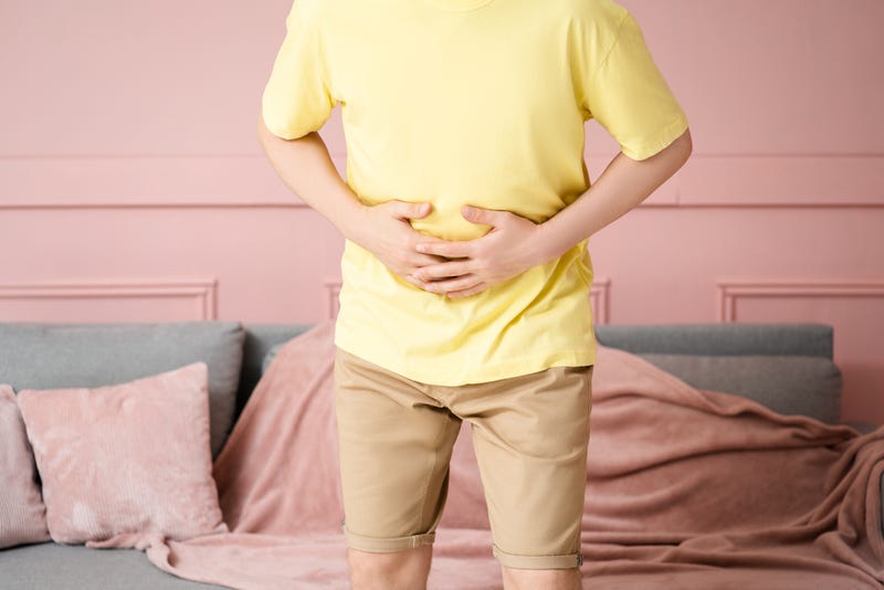 Stomach ache, man with abdominal pain suffering at home, health problems concept