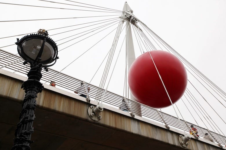 Artist Kurt Perschke's installation 'RedBall' on the Golden Jubilee footbridge on June 27, 2012 in London, England
