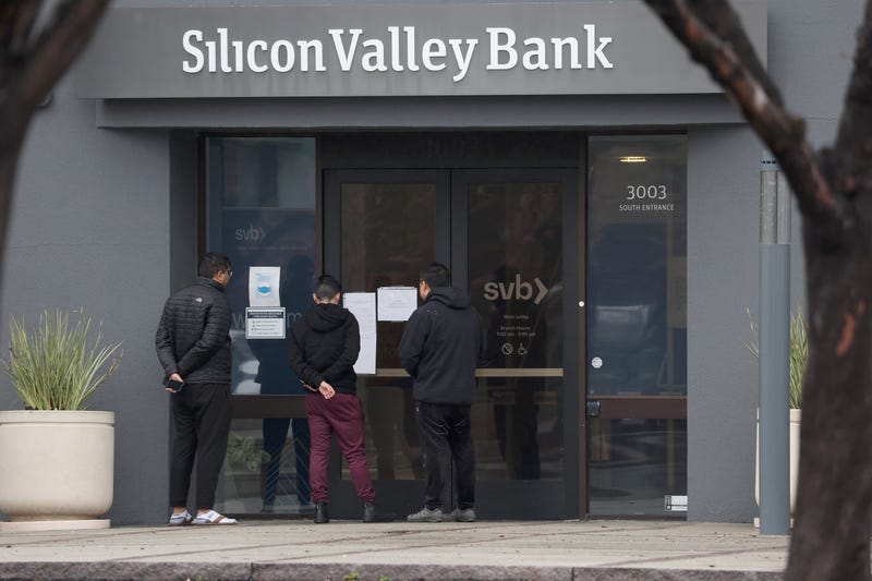 Employees stand outside of the shuttered Silicon Valley Bank (SVB) headquarters on March 10, 2023, in Santa Clara, California. Silicon Valley Bank was shut down on Friday morning by California regulators and was put in control of the U.S. Federal Deposit Insurance Corporation.
