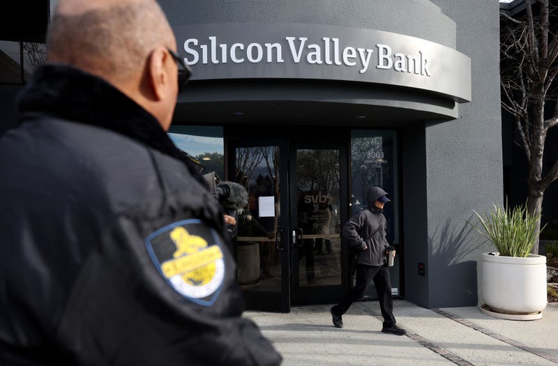 A security guard watches a customer leave a Silicon Valley Bank office on March 13, 2023 in Santa Clara, California.