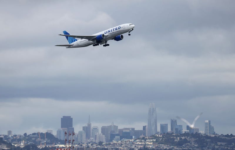 A United Airlines plane takes off from San Francisco International Airport in front of the San Francisco skyline on March 13, 2023 in San Francisco, California.