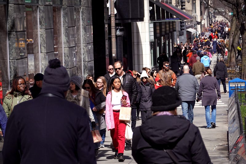 People walk along the Magnificent Mile shopping district