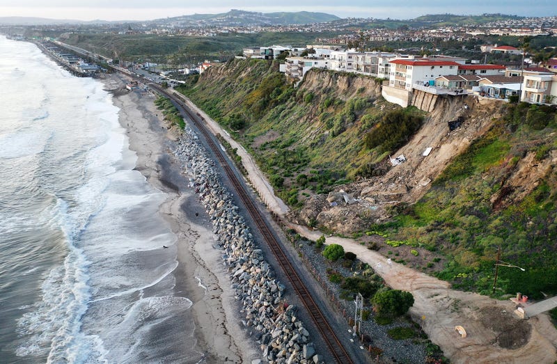 landslide down hill by railroad tracks