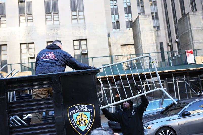 Metal barricades are unloaded in front of Manhattan Criminal Court on March 20, 2023