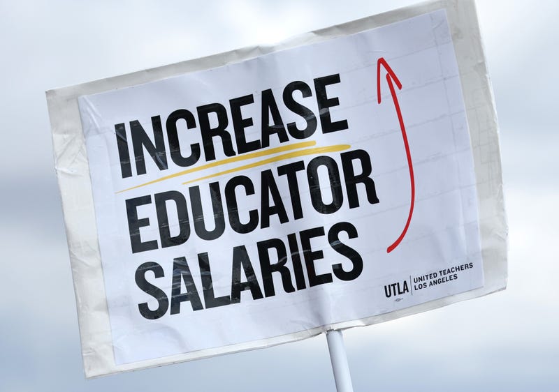 LOS ANGELES, CALIFORNIA - MARCH 23: A sign reads 'Increase Educator Salaries' as Los Angeles Unified School District (LAUSD) workers and supporters rally in Los Angeles State Historic Park on the last day of a strike over a new contract on March 23, 2023 in Los Angeles, California.
