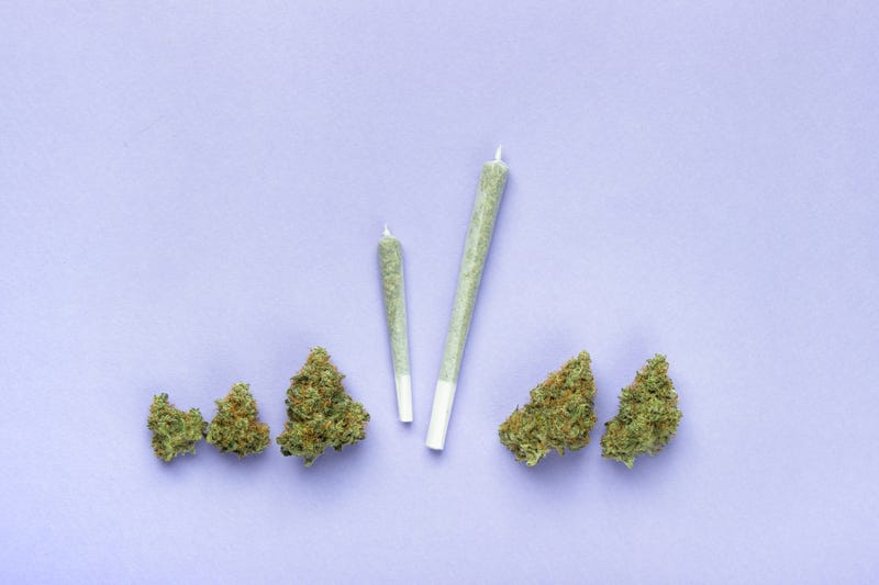 Two joints and dry buds of marijuana.
