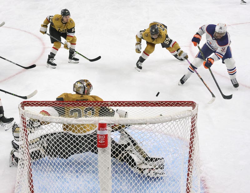 Evander Kane #91 of the Edmonton Oilers scores a goal, his 300th career NHL goal, against Jonathan Quick #32 and Keegan Kolesar #55 of the Vegas Golden Knights in the second period of their game at T-Mobile Arena on March 28, 2023 in Las Vegas, Nevada.