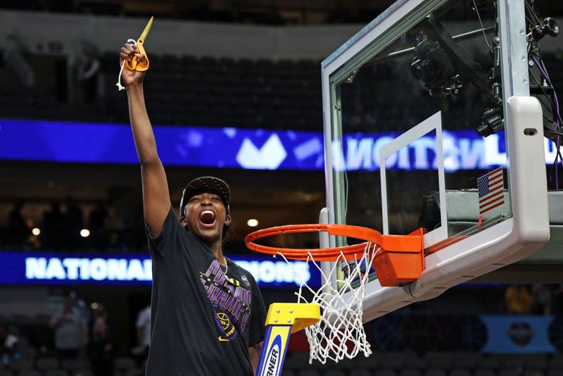 Flau'jae Johnson #4 of the LSU Lady Tigers cuts down a piece of the net after defeating the Iowa Hawkeyes 102-85 during the 2023 NCAA Women's Basketball Tournament championship game at American Airlines Center on April 02, 2023 in Dallas, Texas. (Photo by Tom Pennington/Getty Images)