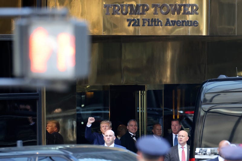 Former President Donald Trump pumps his fist as he departs Trump Tower for his arraignment on April 4, 2023
