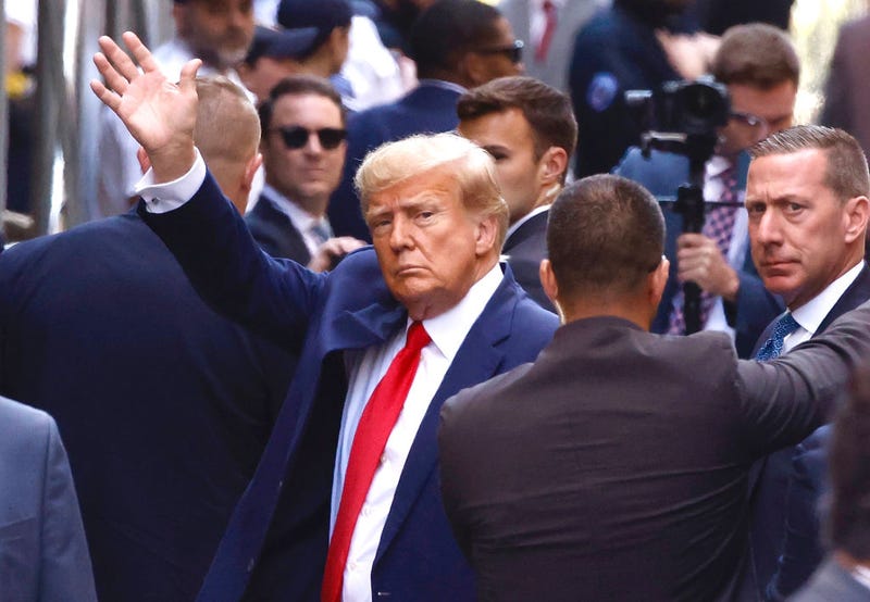 Former U.S. President Donald Trump waves as he arrives at the Manhattan Criminal Court on April 04, 2023 in New York, New York.