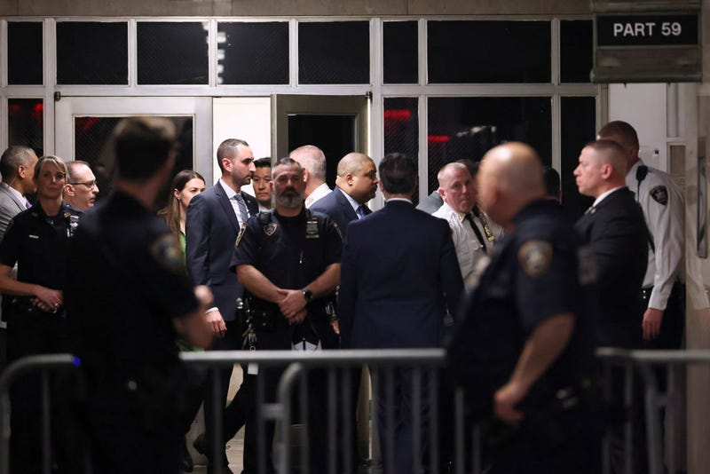 Manhattan District Attorney Alvin Bragg (C) walks through a hallway of the Manhattan Criminal Court during former U.S. President Donald Trump's arraignment on April 04, 2023, in New York, New York.