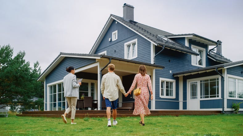 Young couple viewing a home with a realtor. 