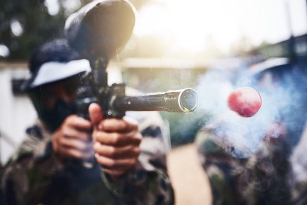 Closeup of player shooting paintball gun