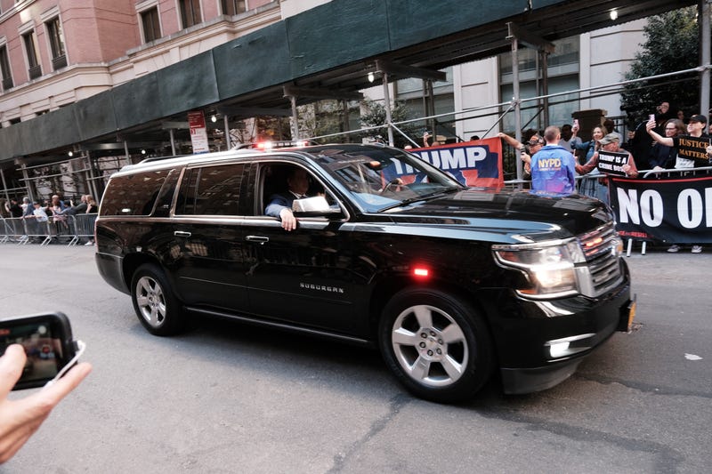 Trump's motorcade is greeted by both protesters and supporters of the former president as he arrives at the attorney general's office in Lower Manhattan on April 13, 2023