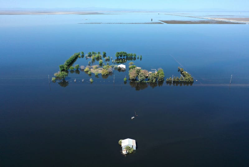 An aerial view of a home (C) surrounded by floodwaters in the reemerging Tulare Lake, in California’s Central Valley, on April 14, 2023 in Corcoran, California. 
