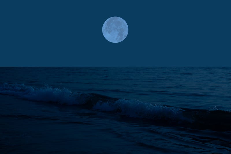 full moon over the ocean