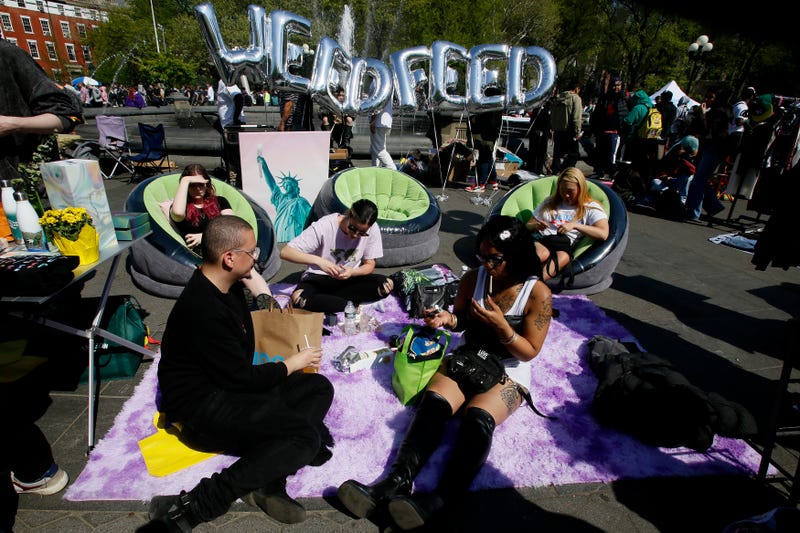 People smoke cannabis at Washington Square Park on April 20, 2023