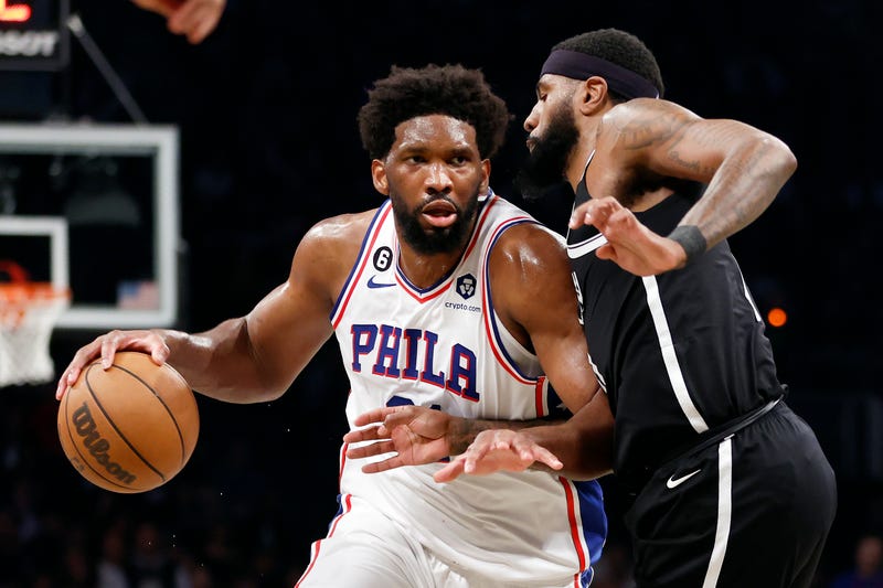 Joel Embiid of the Philadelphia 76ers dribbles against Royce O'Neale of the Brooklyn Nets during the second half of Game Three of the Eastern Conference First Round Playoffs at Barclays Center on April 20, 2023.