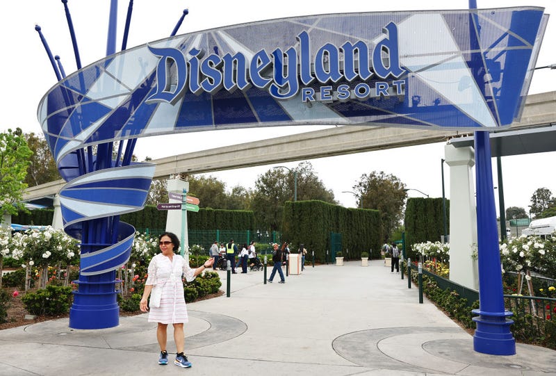 A person poses for a photo at an entrance to Disneyland on April 24, 2023 in Anaheim, California. 