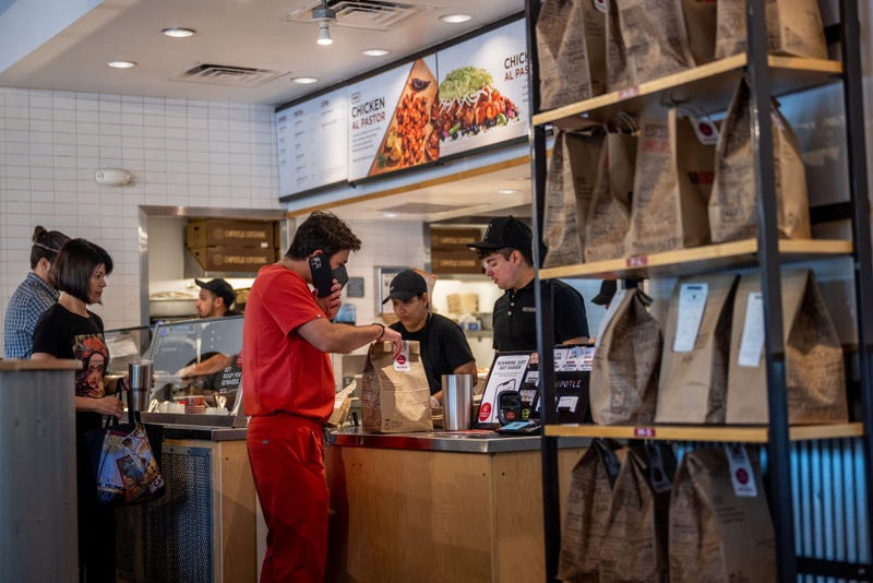 Customers order food at a Chipotle Mexican Grill restaurant on April 26, 2023 in Austin, Texas. Chipotle Mexican Grill posted strong quarterly earnings. Chipotle shares climbed as same-store sales rose 10.9%. (Photo by Brandon Bell/Getty Images)