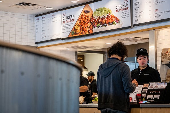 A customer pays for their food at a Chipotle Mexican Grill restaurant on April 26, 2023 in Austin, Texas. Chipotle Mexican Grill posted strong quarterly earnings. Chipotle shares climbed as same-store sales rose 10.9%. 