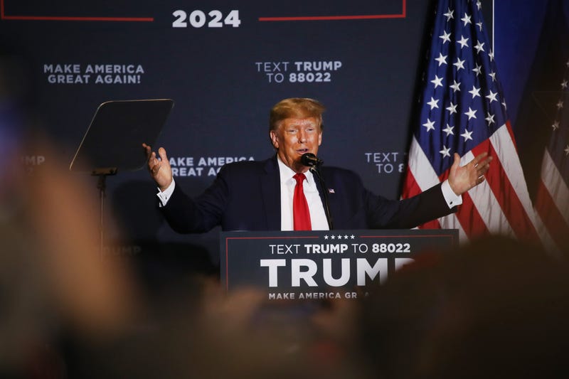 trump speaks onstage at campaign event