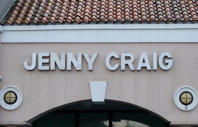 A Jenny Craig sign hangs on the wall outside of the weight loss store on April 28, 2023 in Miami, Florida.