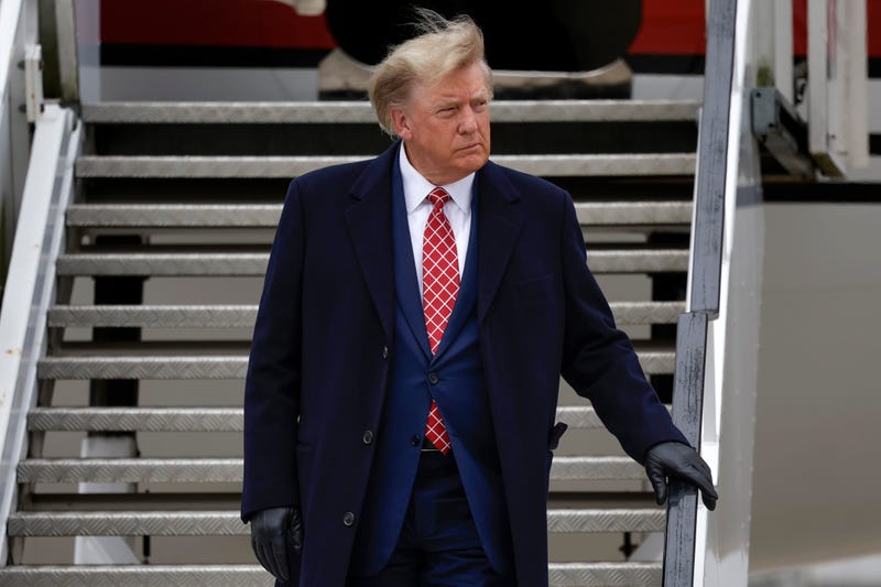 trump on stairs exiting plane