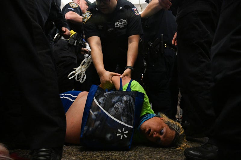 NYPD officers arrest protesters at the Lexington Ave/63rd Street subway station on May 6, 2023
