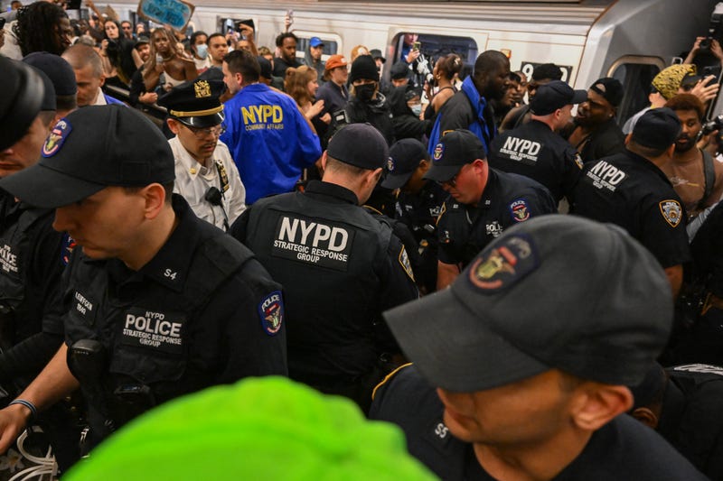 NYPD officers arrests protesters in the Lexington Ave/63rd Street subway Station during a "Justice for Jordan Neely" protest on May 6, 2023