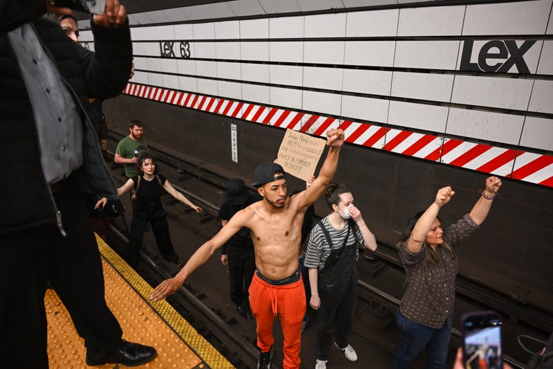 Protesters stand on the tracks at the Lexington Ave/63rd Street subway station on May 6, 2023