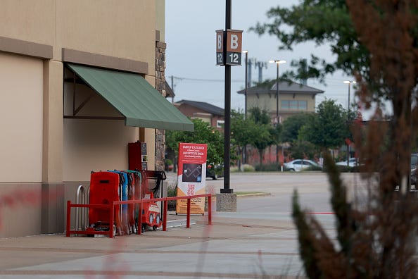 A sign stands in front of a store near the scene of a mass shooting at the Allen Premium Outlets mall on May 9, 2023