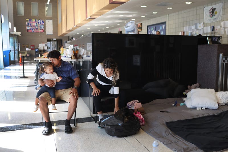 migrants at police station lobby