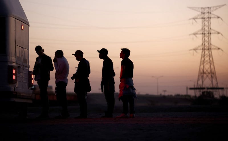 Immigrants seeking asylum wait to board a bus to a U.S. Border Patrol processing center, after crossing into Arizona from Mexico, on May 11, 2023 in Yuma, Arizona. A surge of immigrants is expected with today's end of the U.S. government's Covid-era Title 42 policy, which for the past three years has allowed for the quick expulsion of irregular migrants entering the country. Over 29,000 immigrants are currently in the custody of U.S. Customs and Border Protection ahead of the sunset of the policy tonight. (Photo by Mario Tama/Getty Images)