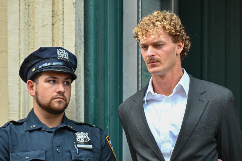 Daniel Penny is escorted in handcuffs by the NYPD after turning himself into the 5th Precinct on May 12, 2023