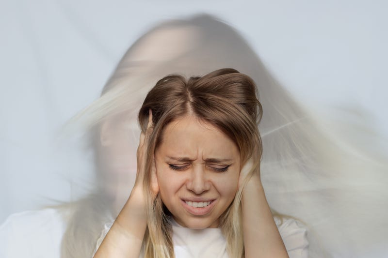 Woman covering her ears.