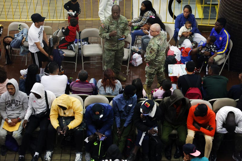 Newly arrived asylum seekers wait in a holding area at the Port Authority bus terminal before being sent off to area shelters and hotels on May 15, 2023, in New York City. 