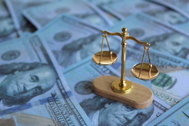 Balancing scale on top of money. Law, bribery, justice and corruption concept