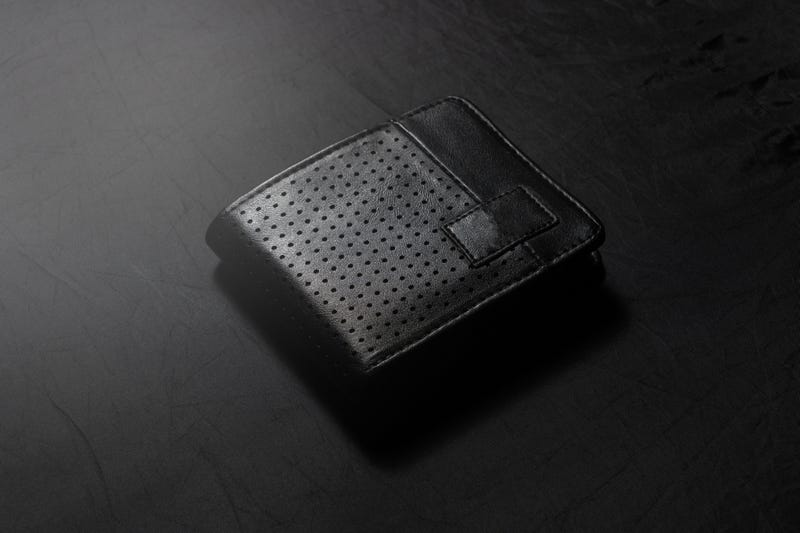 black leather wallet on dark background low key photo