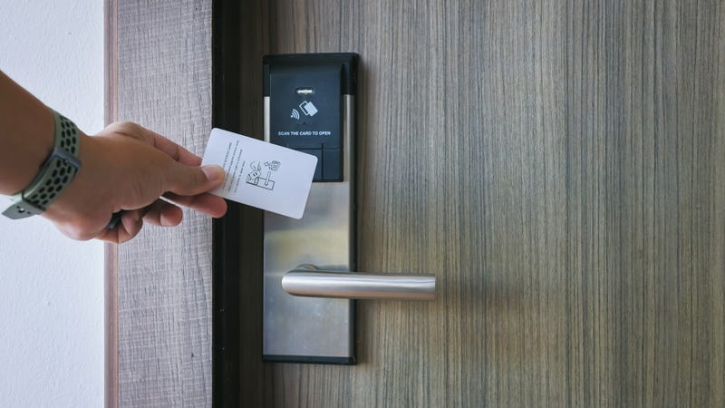 Stock photo of person using hotel key card