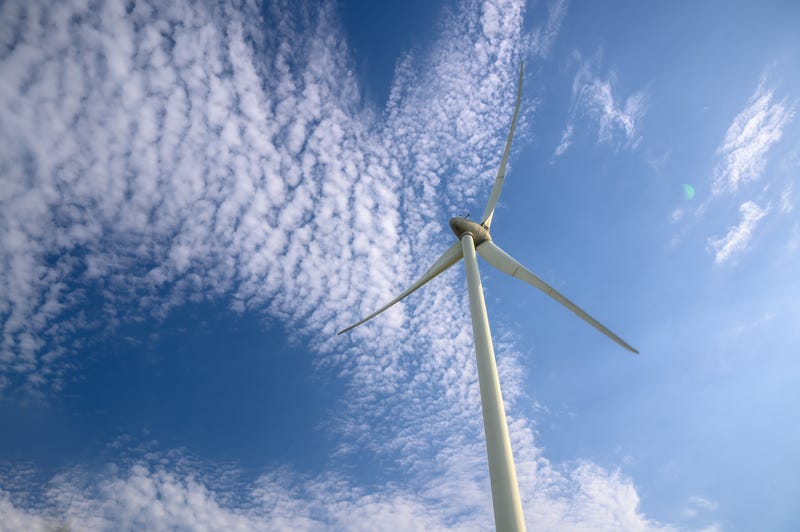 Low angle shot of offshore wind turbine.