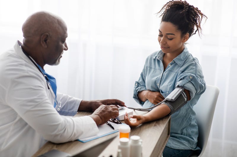 Doctor checking a patient's blood pressure
