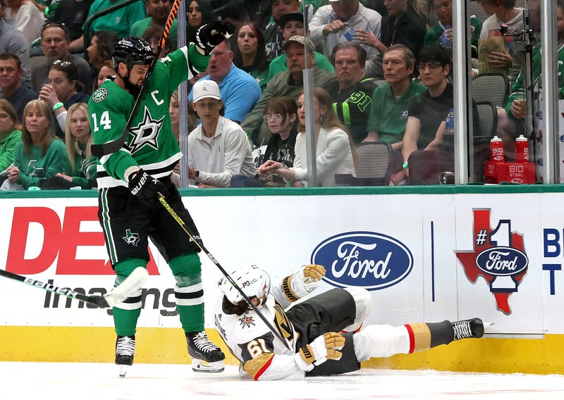 Jamie Benn #14 of the Dallas Stars is called for a 5-minute major and a game misconduct for a cross-checking penalty against Mark Stone #61 of the Vegas Golden Knights