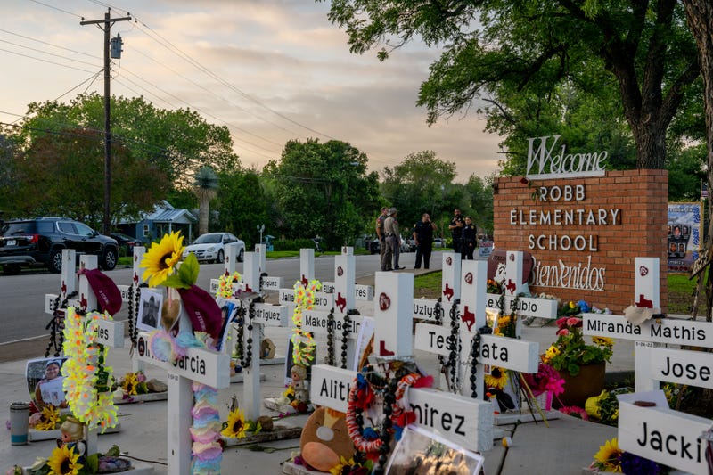 Law enforcement stand watch near a memorial dedicated to the 19 children and two adults murdered on May 24, 2022, during the mass shooting at Robb Elementary School on May 24, 2023, in Uvalde, Texas.