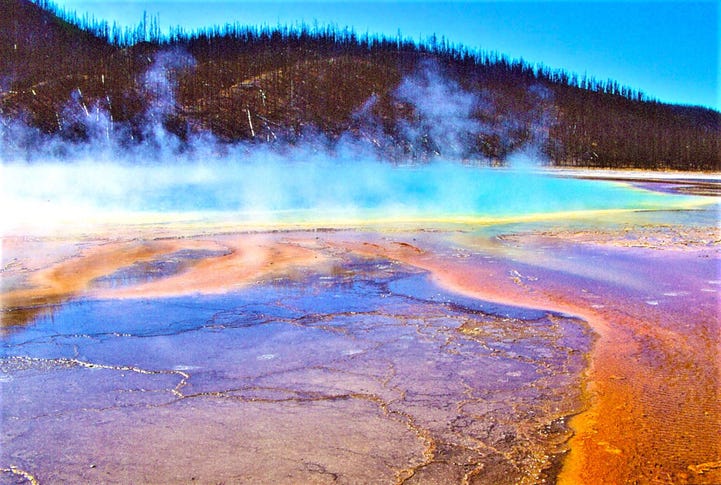 Grand Prismatic Spring - Yellowstone NP, WY - stock photo Hot spring with all the colors of a paint pot: glacier blue, brown, burnt orange, yellow and gun metal blue. All of this in beautiful swirls and curls and white steam rising from the water.